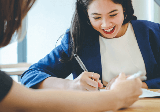 volunteer attorney smiling and writing on paper