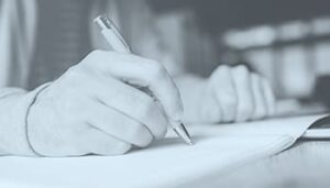 hand holding pen writing a list
