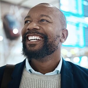 middle age man wearing sweater and suit jacket smiling