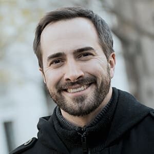 middle age man smiling in black coat